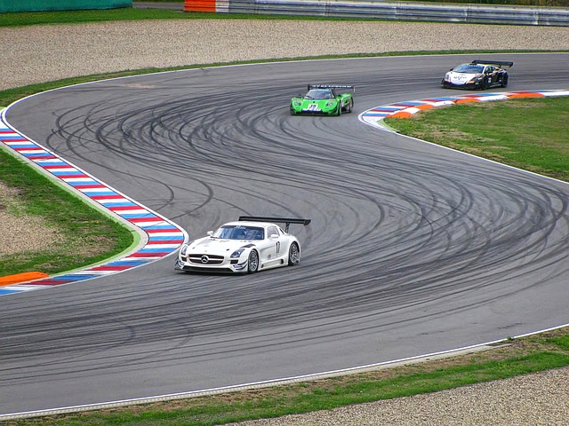 3 race cars are shown navigating a race track